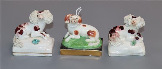 English porcelain figures of a pair of recumbent poodles and a King Charles spaniel, c.1830-50, possibly Davenport,